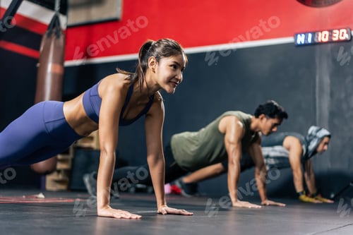 Preview: Group of young athlete male and female exercising together in fitness.