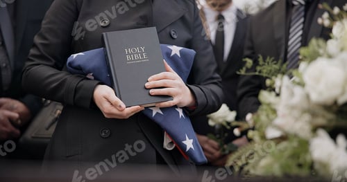 Preview: Hands, american flag and bible with a person at a funeral, grieving a loss at a graveyard. War, cem