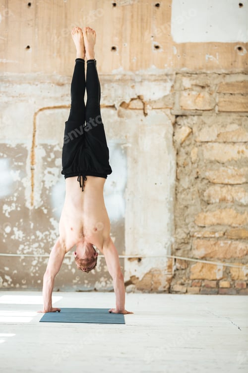 Preview: Strong man doing exercises on a fitness mat