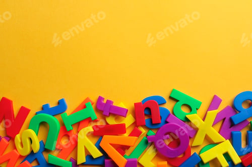 Preview: Plastic magnetic letters on color background, top view with space for text