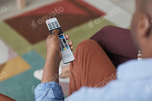 Preview: African American Man Switching Channels on TV