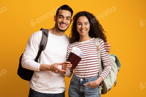 Preview: Happy Travellers. Smiling Arab Couple With Backpacks, Passports And Travel Tickets