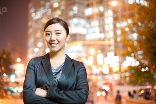 Preview: Chinese businesswoman with city lights in the background