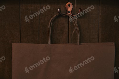 Preview: close-up shot of blank paper bag hanging on wooden wall