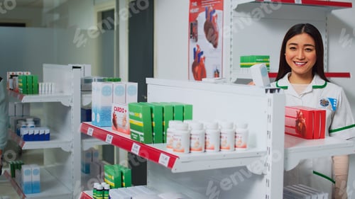 Preview: Young woman working as pharmacist in drugstore