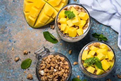Preview: Parfait with yogurt, mango and granola top view.