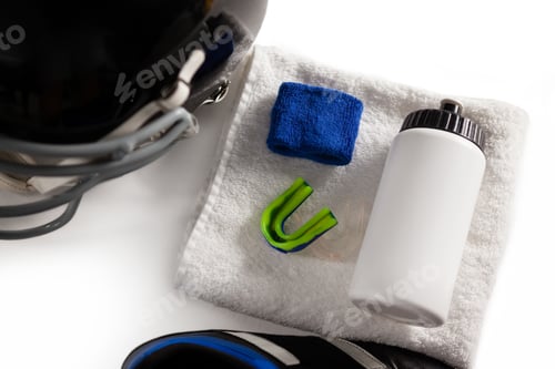 Preview: High angle view of wristband and bottle on napkin