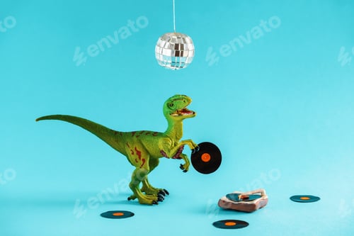 Preview: Cute green dinosaur toy holding a vinyl record and listen vinyl on vinyl record player