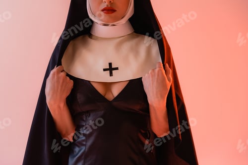Preview: cropped view of sexy nun in black leather dress on pink background