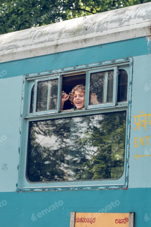 Preview: Excited boy riding train and looking out window