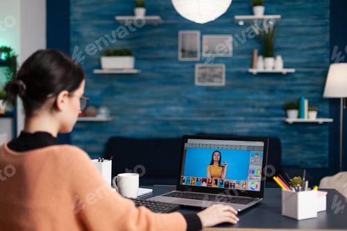 Preview: Graphic designer retouching photos on laptop