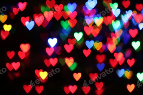 Preview: Blurred view of colorful heart shaped lights on black background