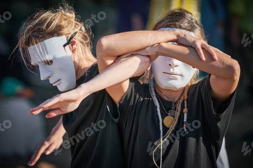 Preview: Two women in white theatre mask dancing on art festival, outdoor art theatrical performance festival