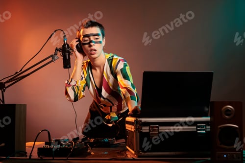 Preview: Happy musician playing with techno music on mixer