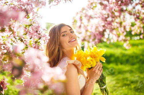 Preview: Spring Style. Beautiful Young Brunette Woman In Nice Spring Dress With A Bouquet Of Tulips.