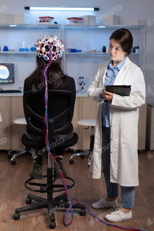 Preview: Woman patient wearing performant eeg headset scanning