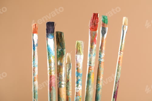 Preview: Dirty paintbrushes on light brown background, closeup
