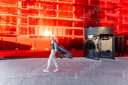 Preview: Fashion of the future. Futuristic blonde in red space.