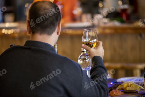 Preview: Selective focus shot of a male drinking champagne