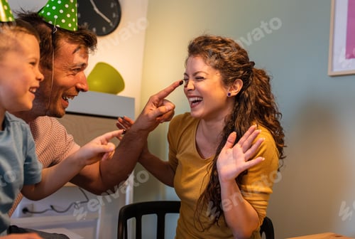 Preview: Happy family celebrating a birthday together at home.