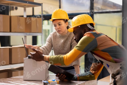 Preview: Worker preparing pallets and cardboard boxes in a shipping facility