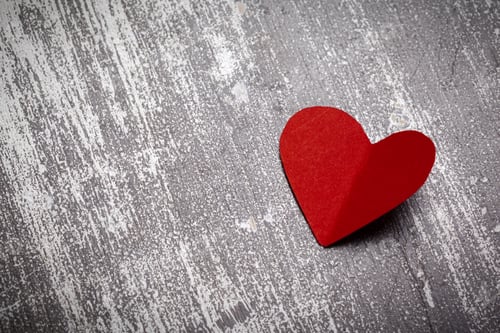 Preview: Red heart shape placed on a textured gray background, symbolizing love and affection
