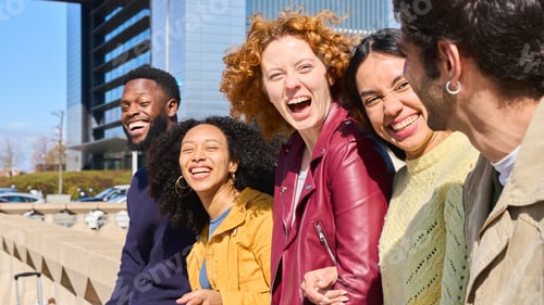 Preview: Happy multi ethnic friends laughing together outdoors in the city