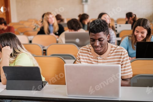 Preview: Group of university students attending class with their computers taking notes