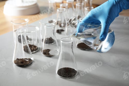 Preview: Scientist preparing soil extract at table, closeup. Laboratory research