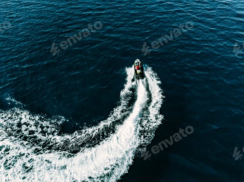 Preview: Aerial view of jet skier in blue sea. Jet ski in turquoise clear water racing