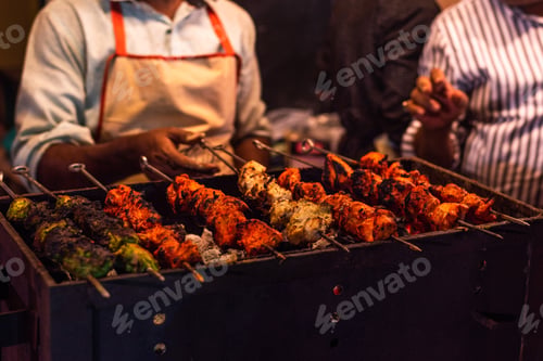 Preview: Traditional grilled tandoori of assorted meats with charcoal and fire on skewers