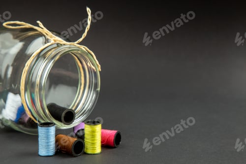Preview: front view colorful threads with can on dark background darkness clothes pin job sewing measure