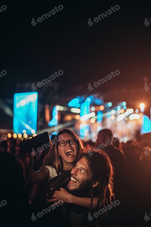 Preview: Excited Friends Enjoying a Nighttime Show Together