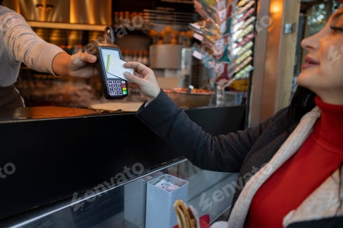 Preview: woman paying with credit card in a street store