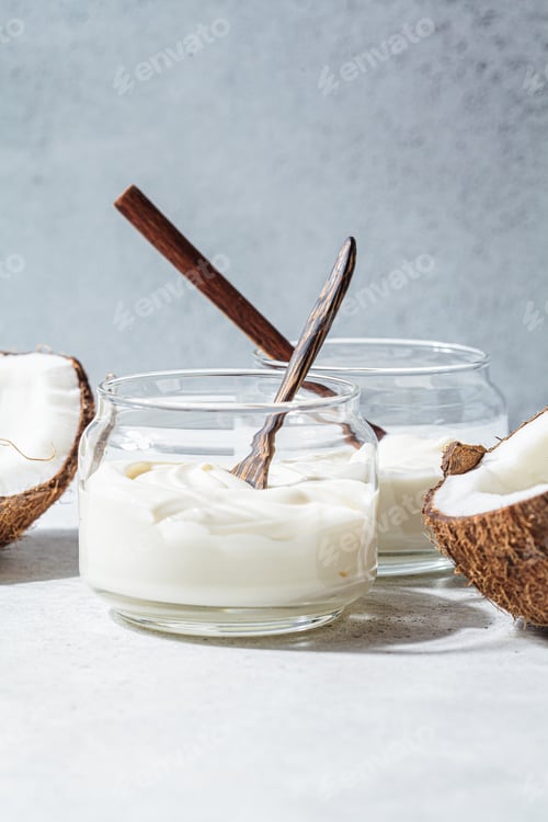 Preview: Vegan coconut yogurt in glass jars, white background. Vegan food concept.