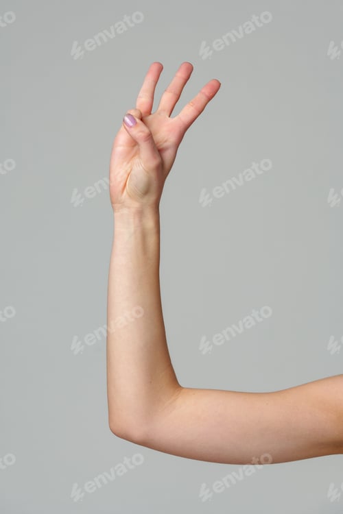 Preview: Female hand gesturing numbers on gray background