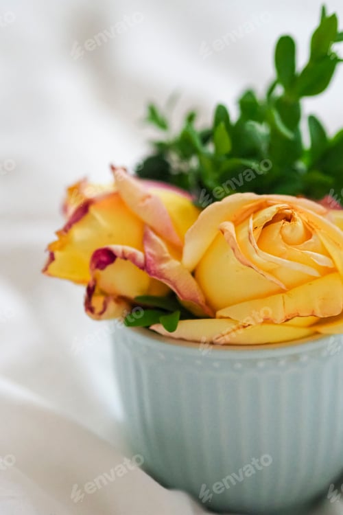 Preview: a light blue bowl with a flower in it and green grass in the middle of