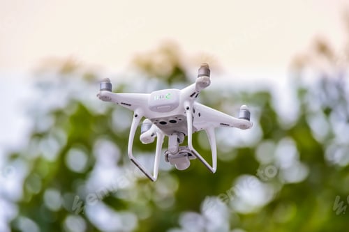Preview: Drone is flying with digital camera to take photo and video on ground floor..