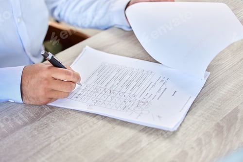 Preview: Patent filling medical form. Closeup of a business man writing on a healthcare document in an offic