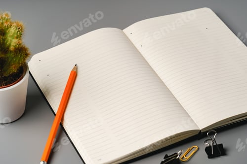 Preview: Blank notebook with pen are on top of office desk table