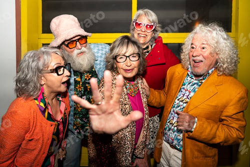 Preview: Group of happy senior friends with fancy clothing having party in the night