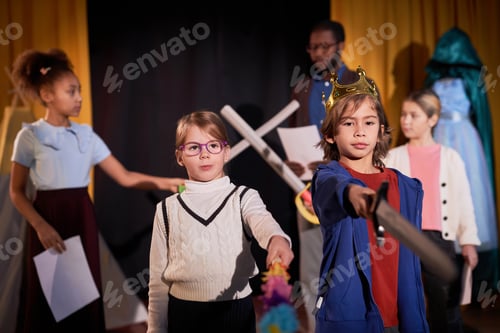 Preview: Boy and Girl Standing on Stage in Theater