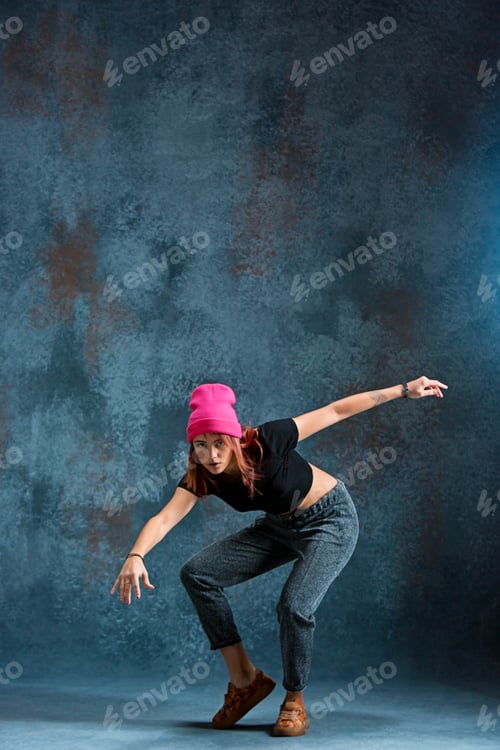 Preview: Young girl break dancing on wall background.