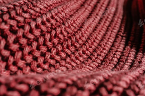 Preview: Knitted texture of a pink sweater or scarf close-up.