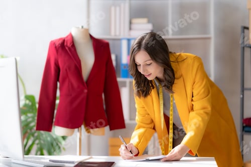 Preview: Beautiful woman designer is drafting clothe to sew beautifully according to fashion trend.