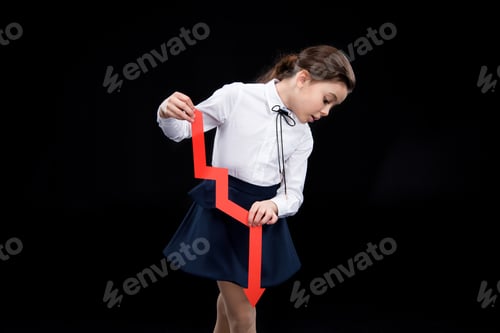 Preview: Adorable girl with red arrow isolated on black