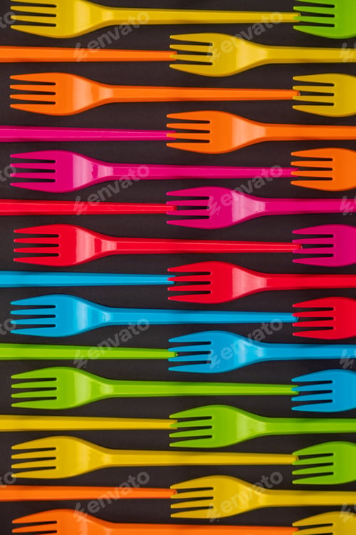 Preview: Many color plastic forks on a bright background