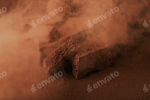 Preview: close up view of heap of chocolate bars in cocoa powder