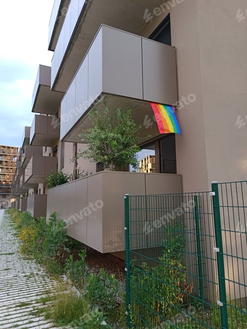 Preview: LGBTQ flag on balcony in multi-apartment building in support of minorities