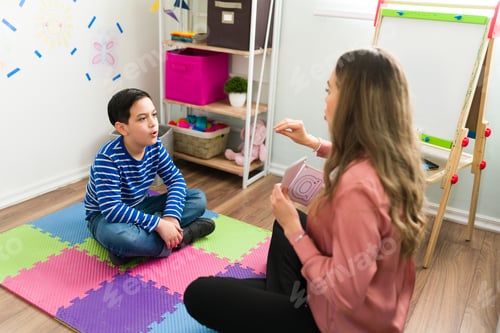 Preview: Female psychologist working with a little boy to treat his speech problem